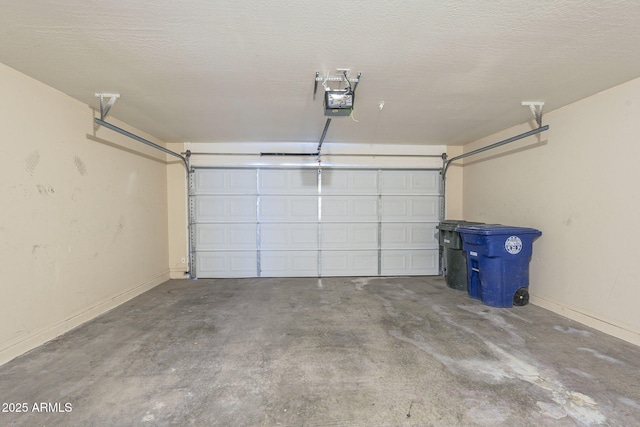 garage with baseboards and a garage door opener