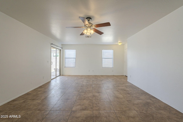 spare room with visible vents, ceiling fan, and tile patterned floors