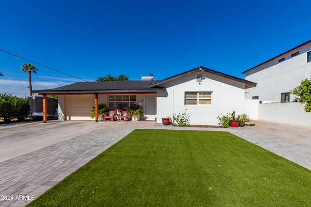 view of front of house with a garage and a front lawn