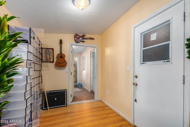 hall with light hardwood / wood-style flooring