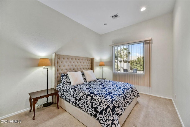 carpeted bedroom featuring lofted ceiling