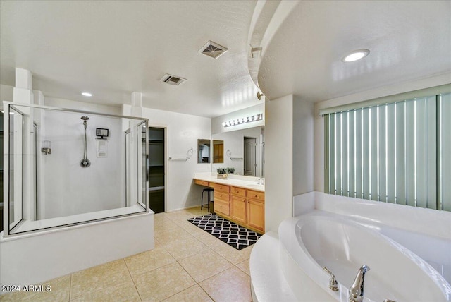 bathroom featuring tile patterned floors, plus walk in shower, vanity, and a textured ceiling