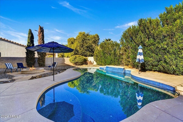 view of pool featuring a patio and an outdoor fire pit