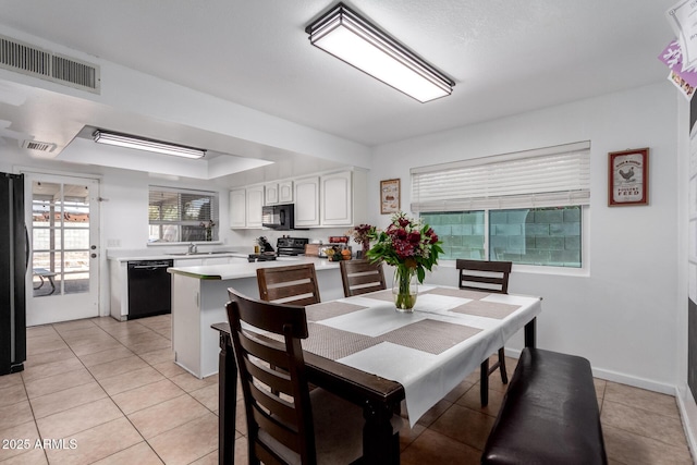 dining room featuring visible vents, baseboards, and light tile patterned flooring