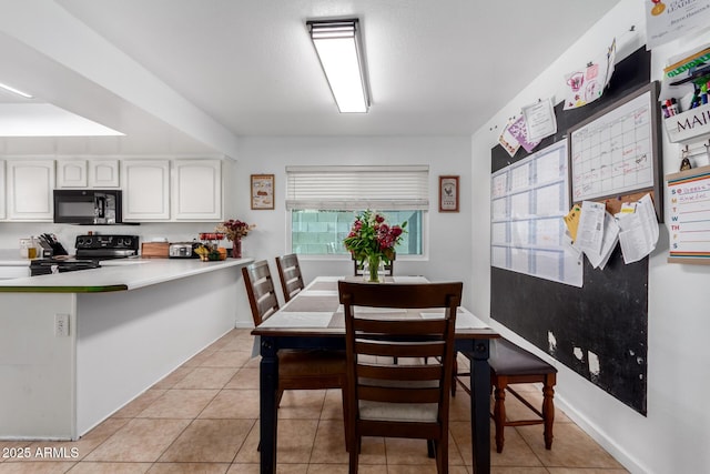 dining space featuring light tile patterned flooring