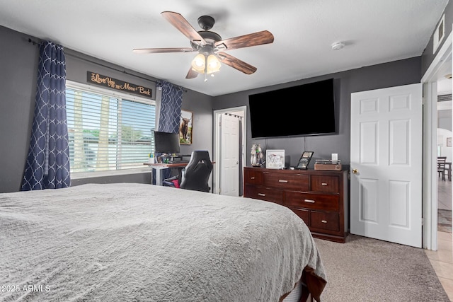 bedroom with ceiling fan and light carpet