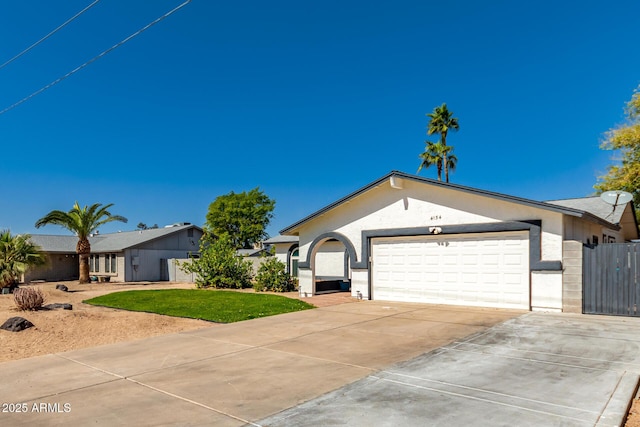 ranch-style home featuring stucco siding, a front yard, fence, a garage, and driveway