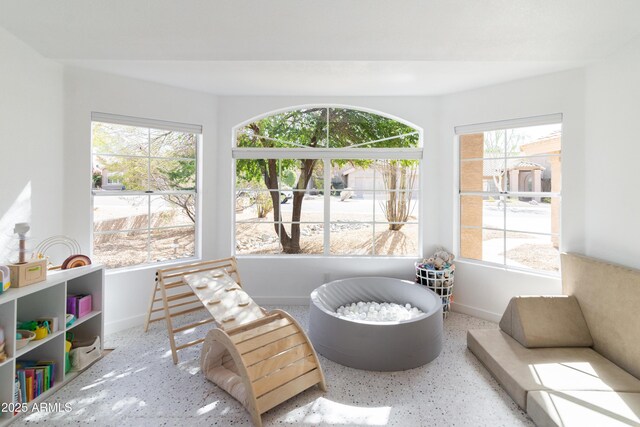 sitting room featuring baseboards and speckled floor