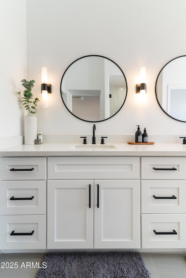 bathroom with a sink and double vanity