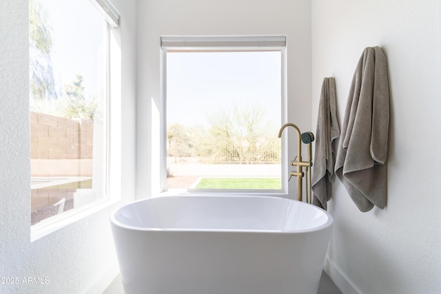 bathroom featuring a soaking tub