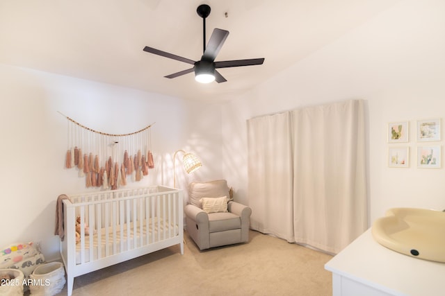 bedroom with light colored carpet, a sink, a ceiling fan, vaulted ceiling, and a nursery area