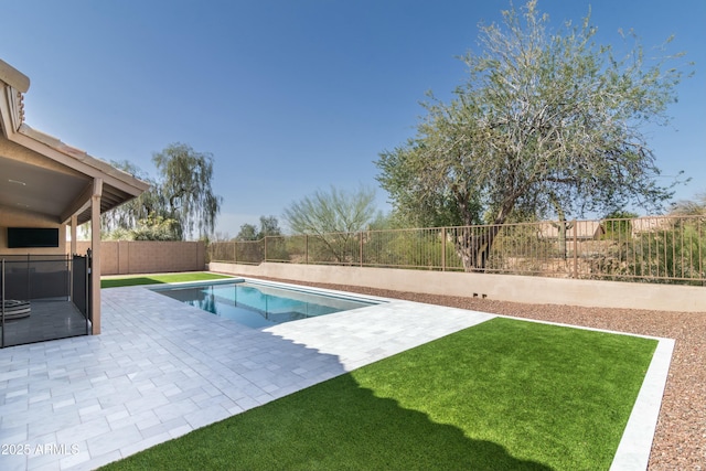 view of pool with a patio area, a fenced backyard, a fenced in pool, and a lawn