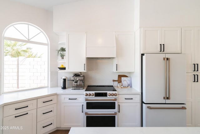 kitchen featuring white cabinetry, custom exhaust hood, open shelves, and premium appliances