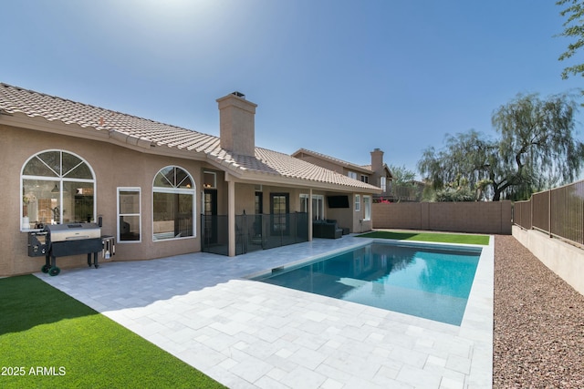 view of swimming pool with area for grilling, a patio area, a fenced backyard, and a fenced in pool