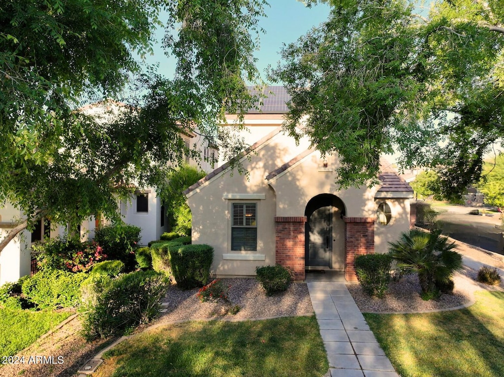 mediterranean / spanish-style house featuring a front lawn