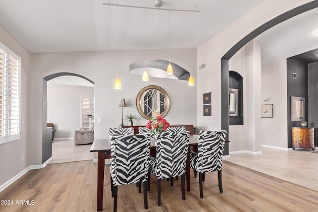 dining room featuring wood-type flooring and track lighting