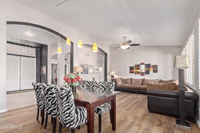 dining area featuring light hardwood / wood-style flooring, ceiling fan, and lofted ceiling