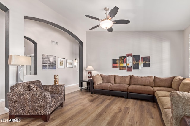 living room featuring wood-type flooring and ceiling fan