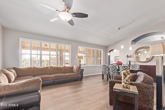 living room featuring light wood-type flooring, track lighting, and ceiling fan