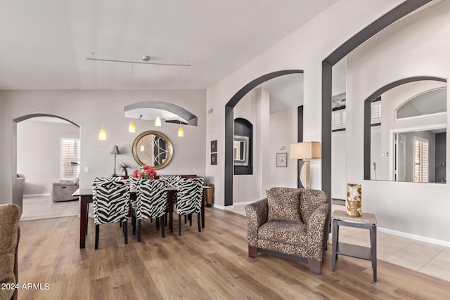 dining space featuring hardwood / wood-style flooring and track lighting