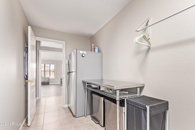 kitchen featuring stainless steel fridge and light tile patterned floors