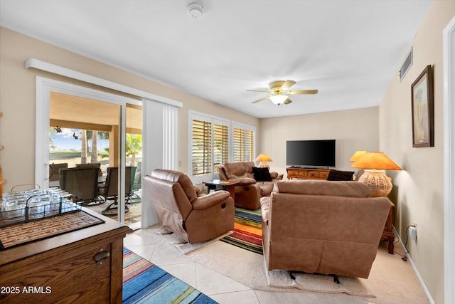 tiled living room featuring ceiling fan