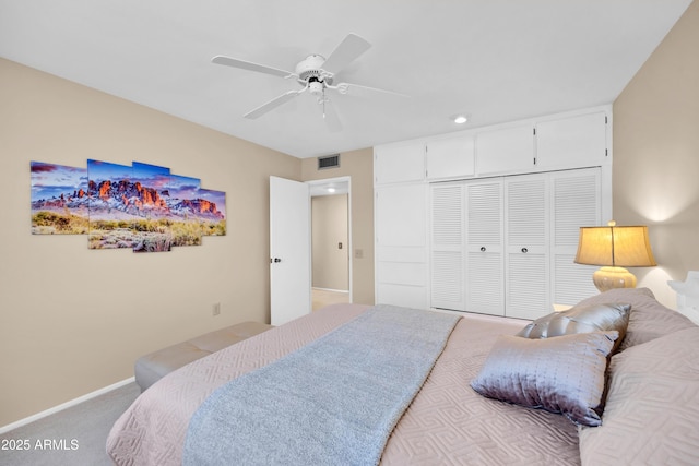 carpeted bedroom featuring ceiling fan and a closet