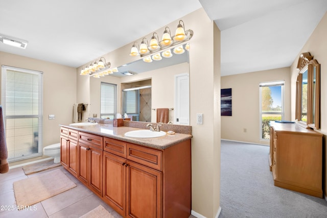 bathroom with walk in shower, vanity, toilet, and tile patterned flooring