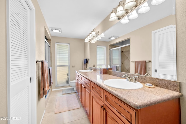 bathroom with vanity, toilet, an enclosed shower, and tile patterned flooring