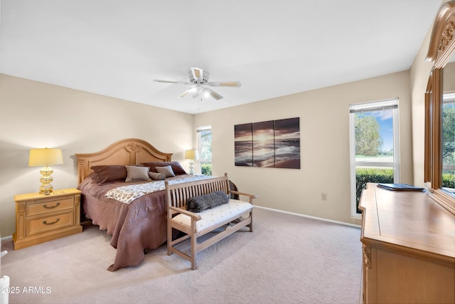 carpeted bedroom featuring ceiling fan and multiple windows