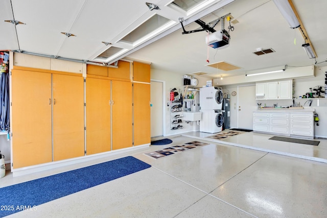 garage featuring a garage door opener and stacked washing maching and dryer