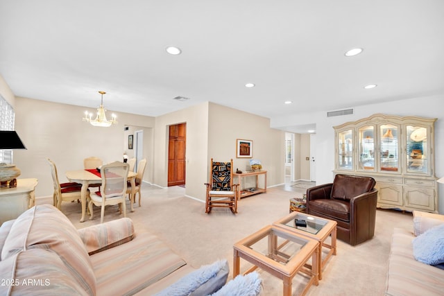 carpeted living room with a chandelier