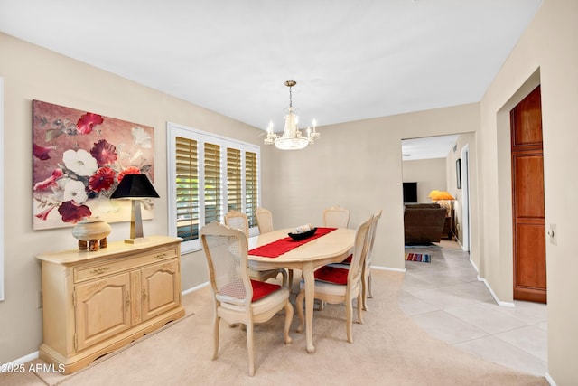 dining room featuring an inviting chandelier and light tile patterned floors