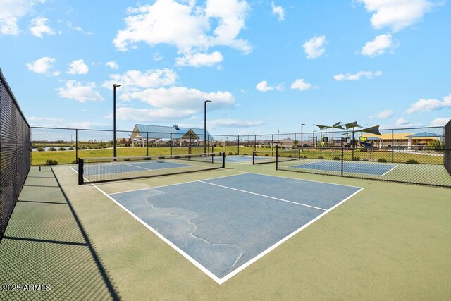 view of sport court featuring fence