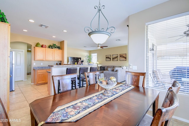 tiled dining room featuring ceiling fan