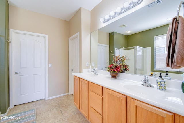 bathroom featuring an enclosed shower, vanity, and tile patterned floors