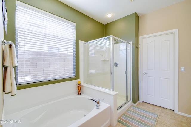 bathroom with separate shower and tub and tile patterned flooring