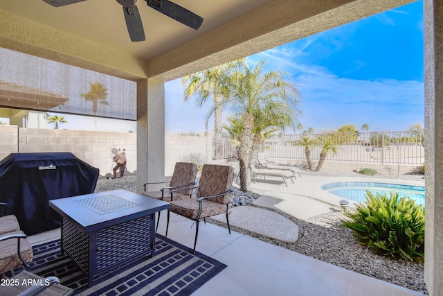 view of patio featuring area for grilling, a fenced in pool, and ceiling fan