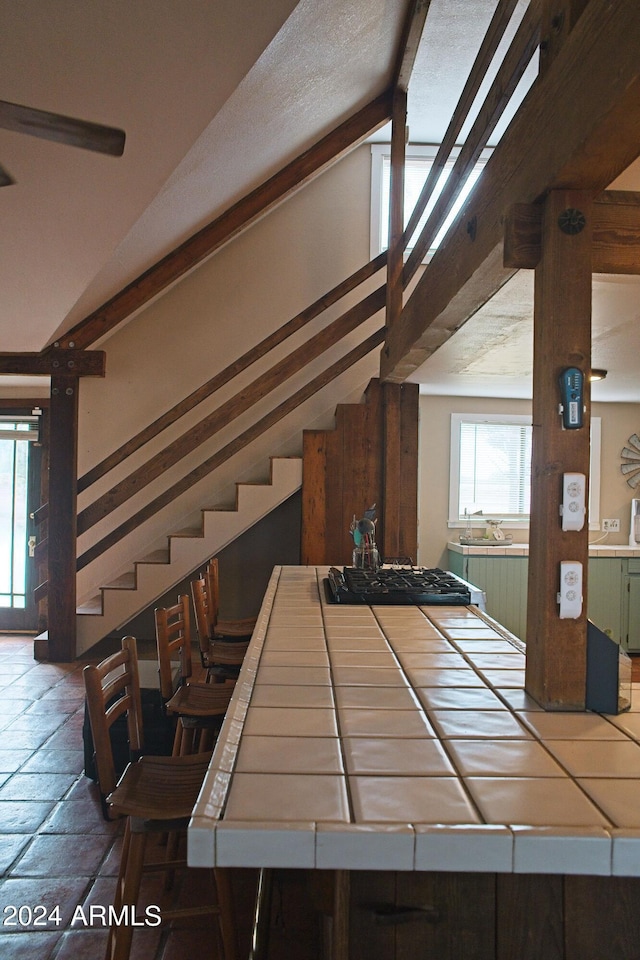 staircase with lofted ceiling with beams