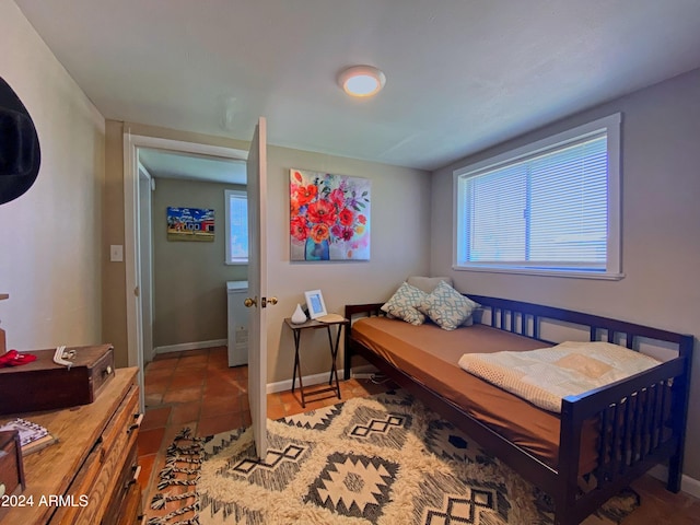 tiled bedroom featuring baseboards