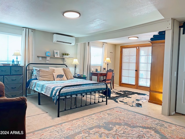 carpeted bedroom featuring a wall mounted AC and a textured ceiling