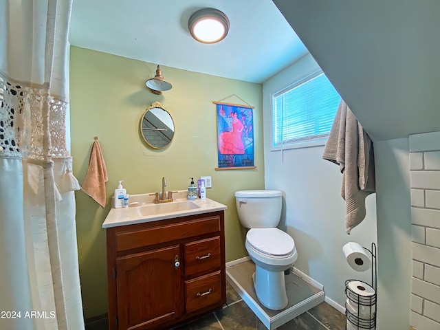 bathroom with baseboards, toilet, and vanity