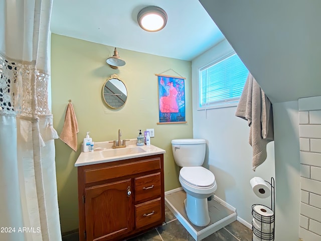 bathroom featuring tile patterned floors, vanity, and toilet