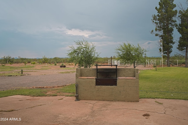 exterior space featuring a rural view and a lawn