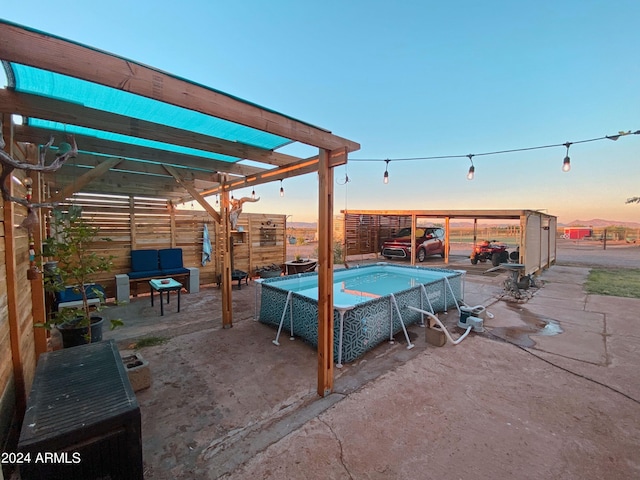 pool at dusk with a jacuzzi, a patio, and fence