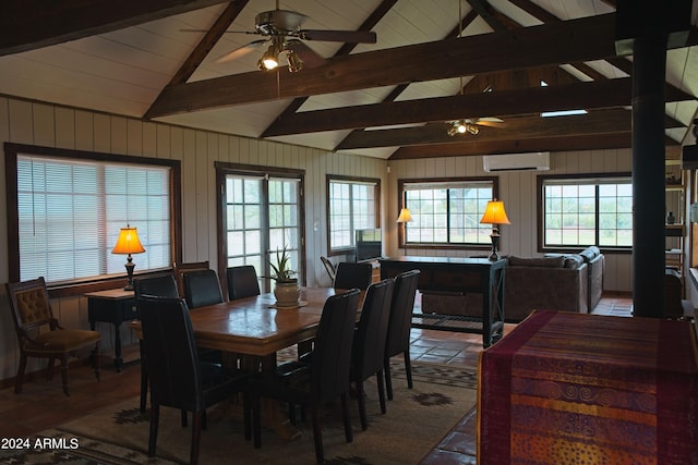 dining space with lofted ceiling with beams, an AC wall unit, ceiling fan, and wood walls