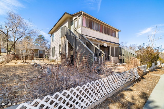 exterior space with a sunroom and stairs