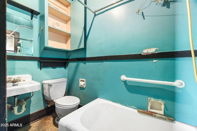 bathroom featuring toilet, baseboards, and a sink