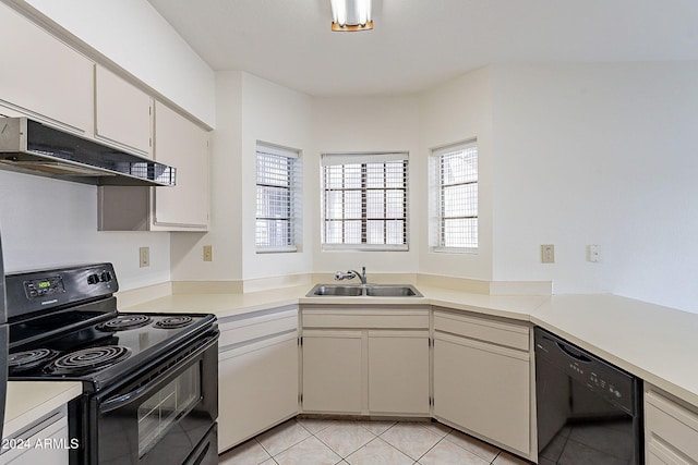 1446 E Grovers Ave Unit 13, Phoenix, AZ 85022 - kitchen with black appliances, under cabinet range hood, light countertops, light tile patterned flooring, and white cabinetry