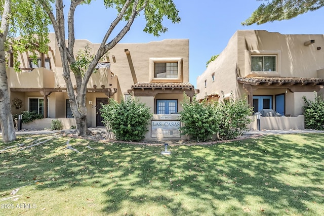 1446 E Grovers Ave Unit 13, Phoenix, AZ 85022 - pueblo revival-style home with stucco siding, a front lawn, and a tiled roof